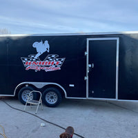 a black trailer with a logo on the side of it