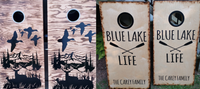 a pair of cornhole game boards with the words blue lake and life painted on