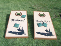 a couple of cornhole boards sitting on top of a grass covered field