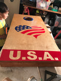 a young boy is playing a game of cornhole