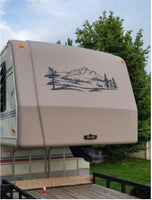 a trailer with a mountain scene painted on the side of it